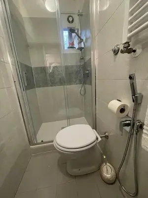 a bathroom with a shower with a toilet and a shower at Termini Station Turati House by Dama in Rome
