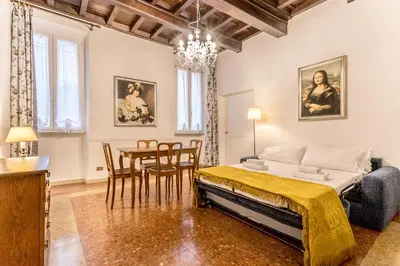 a bedroom with a bed and a table and chairs at Casa Iside in Rome