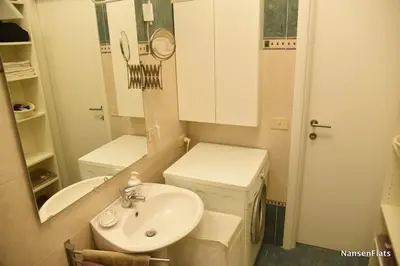 a bathroom with a toilet and a sink and a washing machine at Nansen Flats in Rome