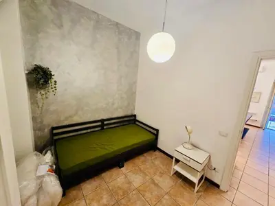 a living room with a couch and a red refrigerator at Nansen Flats in Rome