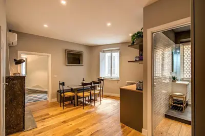 a kitchen and dining room with a table and chairs at Campo di fiori 2 bedroom int 4 in Rome