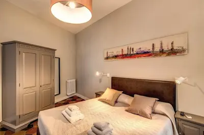 a bedroom with a large bed with white sheets at Campo di fiori 2 bedroom int 4 in Rome