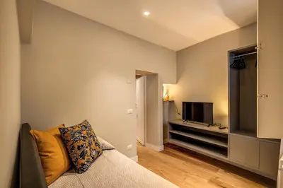 a living room with a couch and a flat screen tv at Campo di fiori 2 bedroom int 4 in Rome