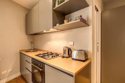 a small kitchen with a stove and a sink at Campo di fiori 2 bedroom int 4 in Rome