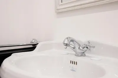 a white bathroom sink with a chrome faucet at Modern and Bright Flat - Rome City Center in Rome