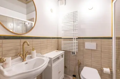 a bathroom with a sink and a mirror at Modern and Bright Flat - Rome City Center in Rome