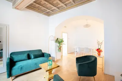 a living room with a blue couch and chairs at Modern and Bright Flat - Rome City Center in Rome