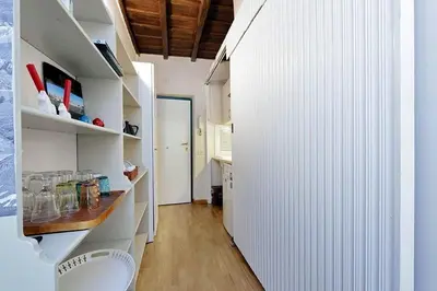 a room with a hallway with white walls and a table at Colosseum Apartment Renovated Via Frangipane in Rome