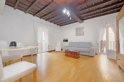 a living room with a couch and a table at Colosseum Apartment Renovated Via Frangipane in Rome