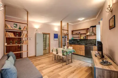 a living room with a table and a kitchen at Cappellari Campo dei Fiori int 2 in Rome