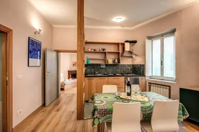 a kitchen and dining room with a table and chairs at Cappellari Campo dei Fiori int 2 in Rome