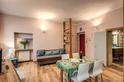 a living room with a table and a couch at Cappellari Campo dei Fiori int 2 in Rome