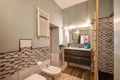 a bathroom with a sink and a toilet and a mirror at Cappellari Campo dei Fiori int 2 in Rome