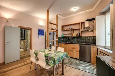 a kitchen with a table and chairs in a room at Cappellari Campo dei Fiori int 2 in Rome