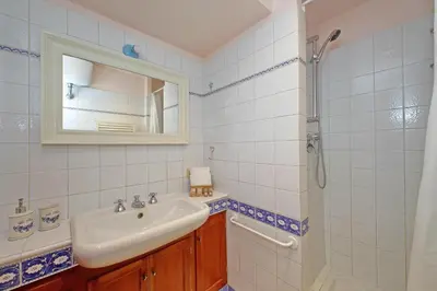 a bathroom with a sink and a mirror and a shower at Leutari in Rome