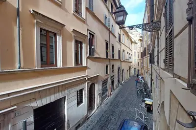 an empty street in an alley between two buildings at Leutari in Rome