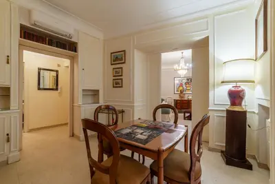 a dining room with a table and chairs at GuestHost - Piazza Navona Elegant Apartment in Rome