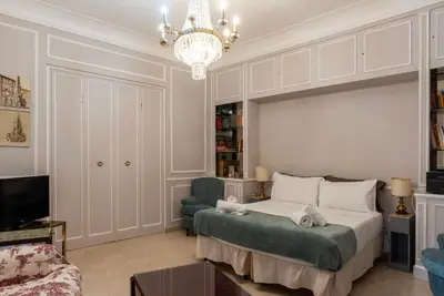 a bedroom with a bed and a chandelier at GuestHost - Piazza Navona Elegant Apartment in Rome