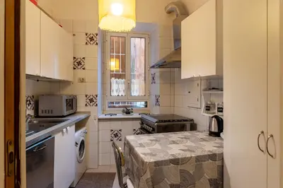 a small kitchen with a table and a stove at GuestHost - Piazza Navona Elegant Apartment in Rome