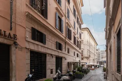 a couple of motorcycles parked next to a building at GuestHost - Piazza Navona Elegant Apartment in Rome