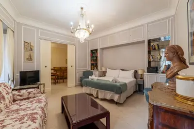 a living room with a bed and a couch at GuestHost - Piazza Navona Elegant Apartment in Rome