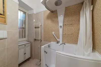 a bathroom with a tub and a shower and a sink at GuestHost - Piazza Navona Elegant Apartment in Rome