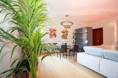 a living room with a couch and a dining room at Divine View Apartment in Rome