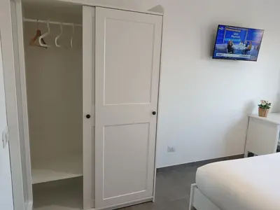 a bedroom with a closet with a white door at Gigli Felici Roma in Rome