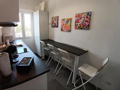 a kitchen with a counter and a table and chairs at Gigli Felici Roma in Rome