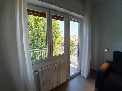 a room with a door with a view of a balcony at Gigli Felici Roma in Rome