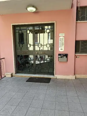 an entrance to a pink building with a glass door at Gigli Felici Roma in Rome