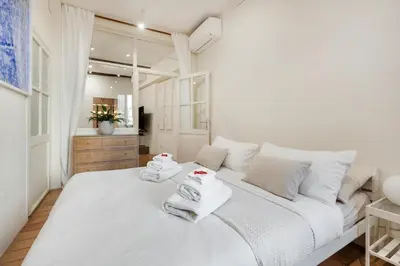 a bedroom with a white bed with towels on it at Leonina Art House in Rome