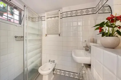 a white bathroom with a toilet and a sink at Leonina Art House in Rome