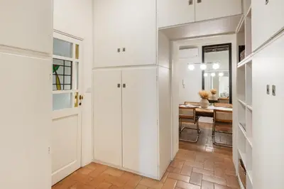 a hallway with white cabinets and a dining room at Leonina Art House in Rome
