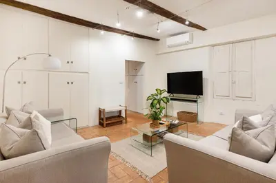 a living room with two couches and a tv at Leonina Art House in Rome