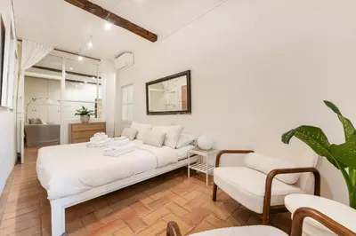 a white bedroom with a white bed and two chairs at Leonina Art House in Rome