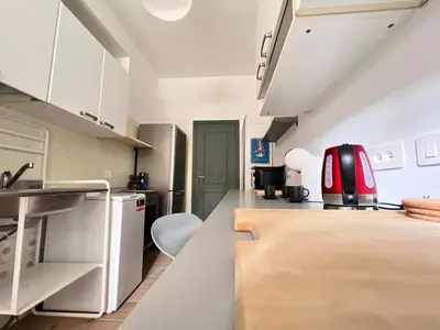 a kitchen with white cabinets and a counter top at La casa di Nina in Rome