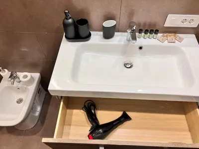 a white sink in a bathroom next to a toilet at La casa di Nina in Rome
