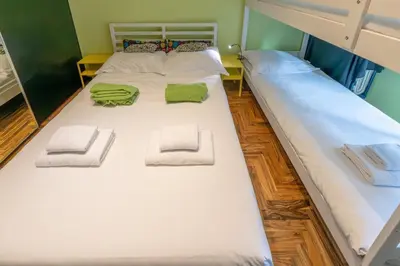 a large white bed with two green towels on it at La Eterna Dimora in Rome