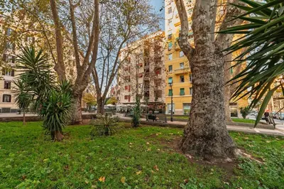 a park with trees and buildings in a city at La Eterna Dimora in Rome