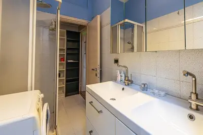a bathroom with a sink and a washing machine at La Eterna Dimora in Rome
