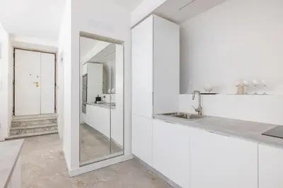 a white bathroom with a sink and mirrors at Cecilia Guest House in Rome