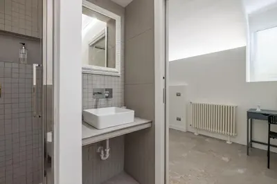 a bathroom with a sink and a mirror at Cecilia Guest House in Rome