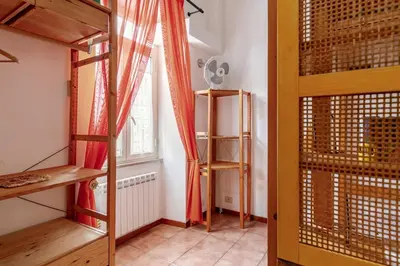 a room with two bunk beds and a window at Cozy studio at pedestrian street in Rome