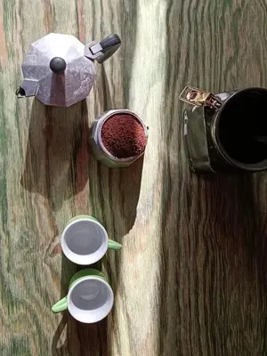 a table with three cups and a pot of coffee at Cozy studio at pedestrian street in Rome