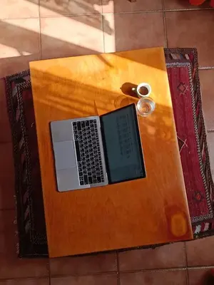 a laptop computer sitting on top of a wooden table at Cozy studio at pedestrian street in Rome