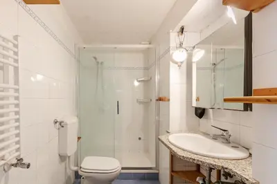 a bathroom with a shower and a toilet and a sink at Cozy studio at pedestrian street in Rome