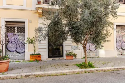 a building with a tree in front of it at Cozy studio at pedestrian street in Rome