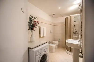 a bathroom with a washing machine and a sink at Cappellari Campo dei Fiori int 3 in Rome