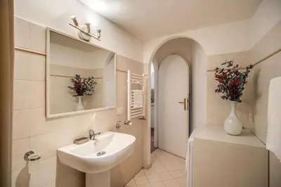 a bathroom with a sink and a mirror and a tub at Cappellari Campo dei Fiori int 3 in Rome